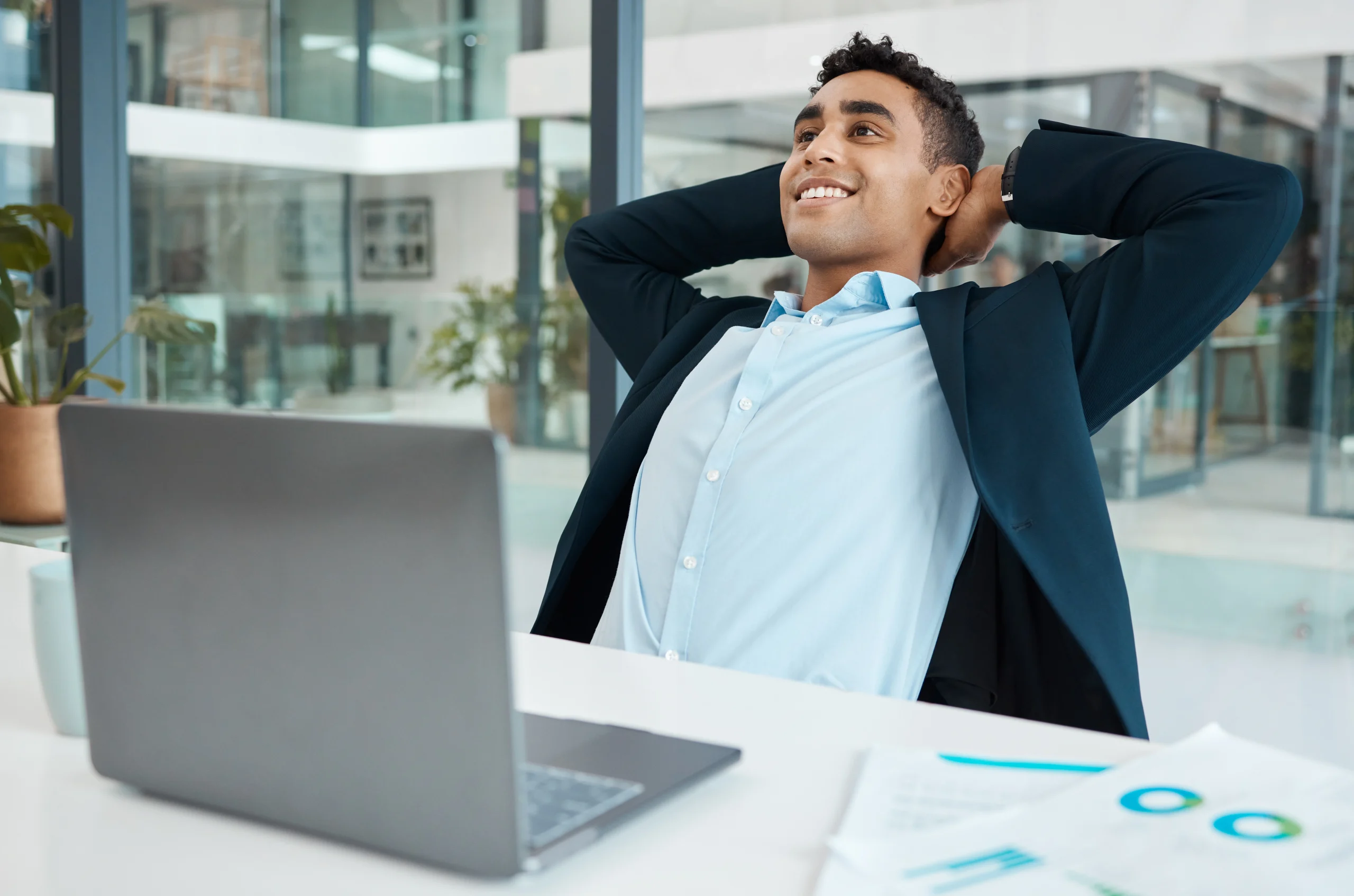 Property investor relaxing at desk knowing rent is paid on time